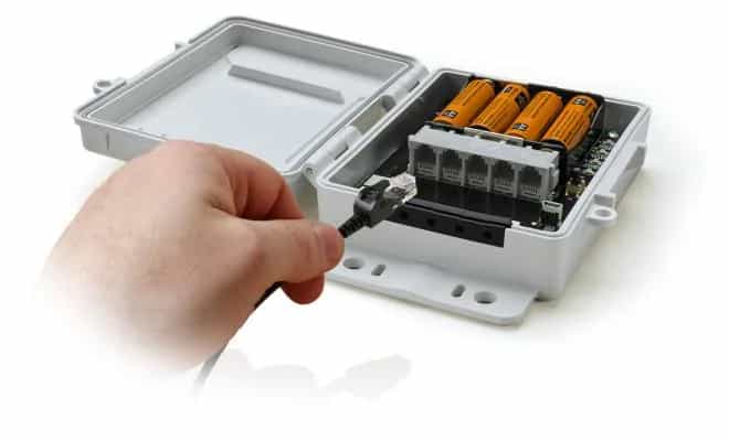 Dłoń podłączająca kabel USB do otwartego rejestratora HOBO Micro Station — odczyt danych (miniatura)