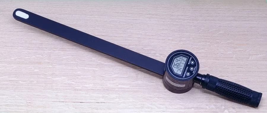 Zbliżenie na aktywny wyświetlacz LCD miernika HIT-RHF podczas pomiaru na drewnianej powierzchni (miniatura)